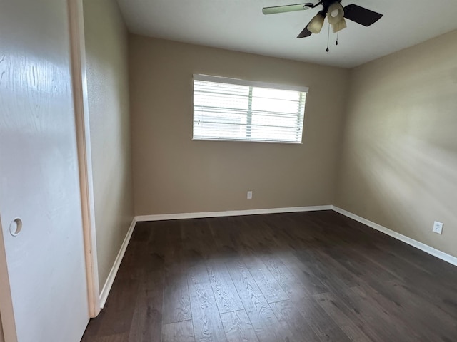 spare room featuring ceiling fan and dark wood-type flooring