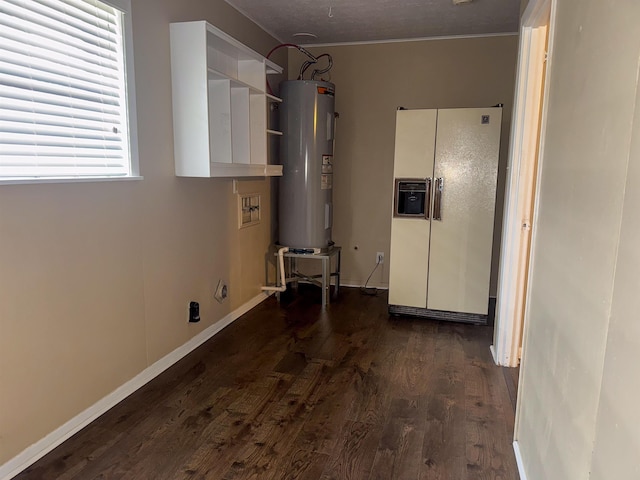 laundry area with dark hardwood / wood-style flooring and electric water heater