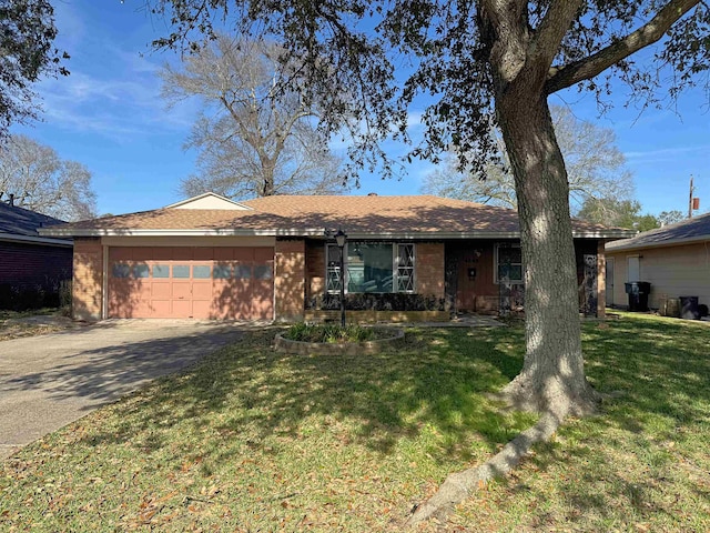 ranch-style house featuring a garage, concrete driveway, brick siding, and a front yard