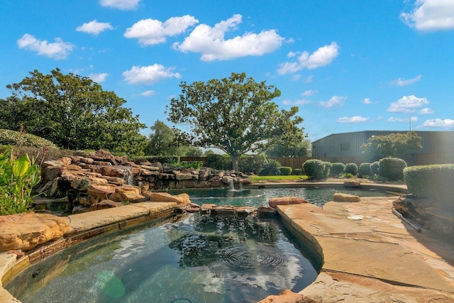 view of swimming pool featuring pool water feature