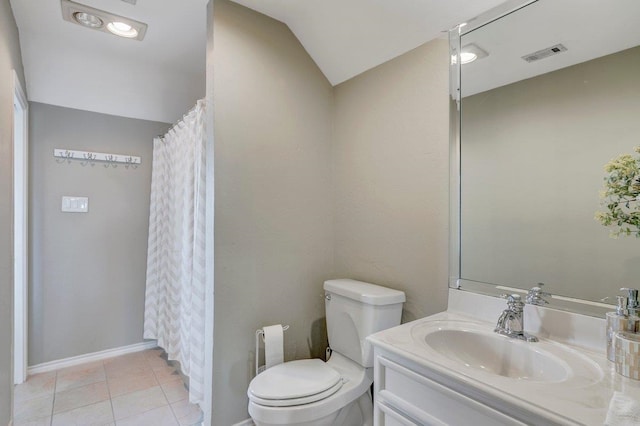 bathroom featuring tile patterned floors, vanity, toilet, and vaulted ceiling