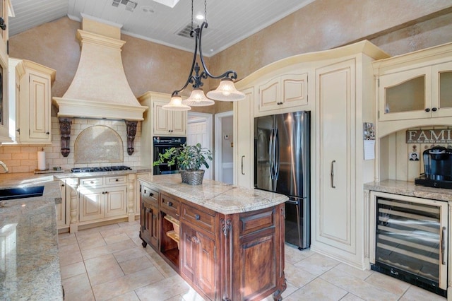 kitchen with appliances with stainless steel finishes, backsplash, sink, pendant lighting, and wine cooler