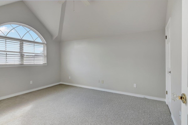 unfurnished room featuring ceiling fan, light colored carpet, and lofted ceiling