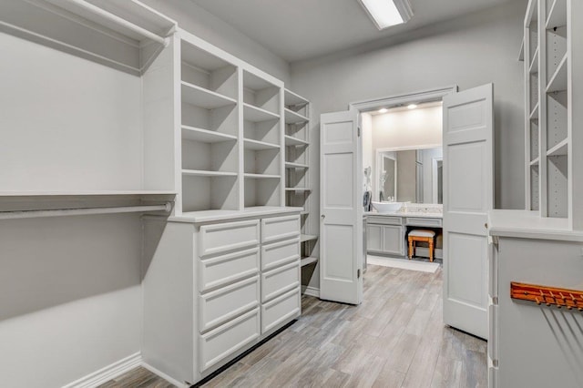 walk in closet featuring light hardwood / wood-style flooring