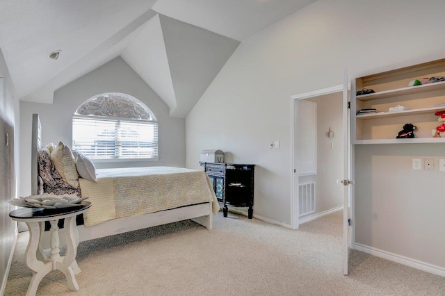 bedroom with light carpet and vaulted ceiling