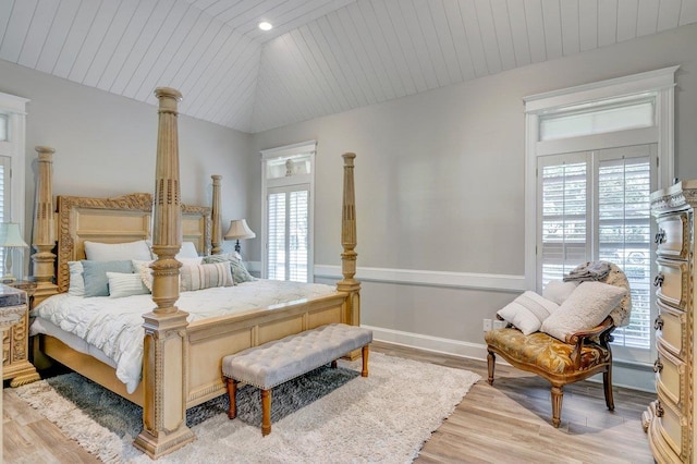 bedroom with lofted ceiling, light wood-type flooring, and wood ceiling