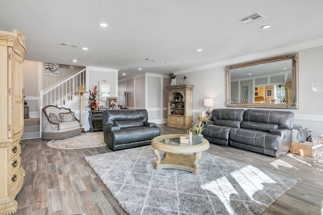 living room with wood-type flooring and crown molding