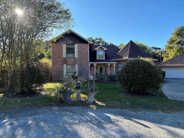 view of front of house with a front yard and a garage