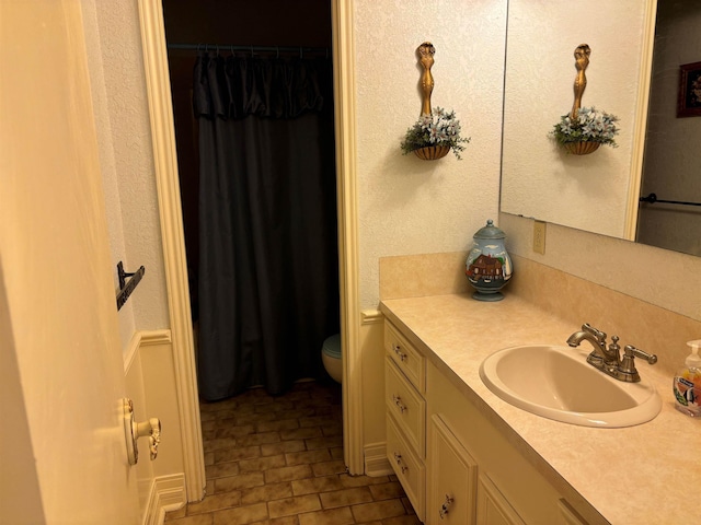 bathroom with vanity and toilet