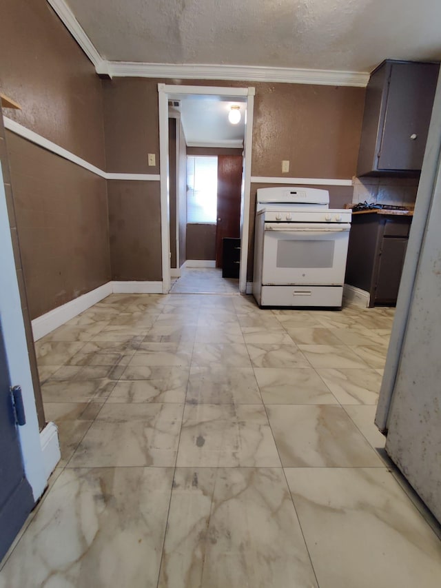 kitchen featuring a textured ceiling, white range oven, and ornamental molding