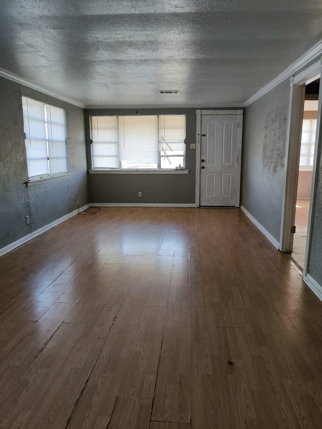 entryway featuring wood-type flooring, a textured ceiling, and crown molding