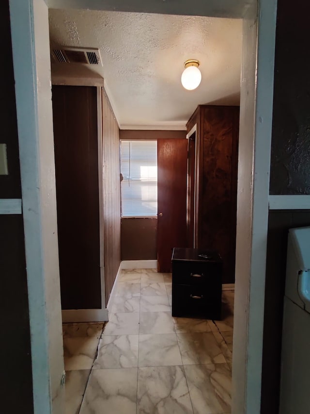 corridor with a textured ceiling