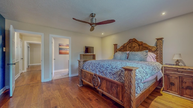 bedroom featuring ceiling fan and hardwood / wood-style flooring