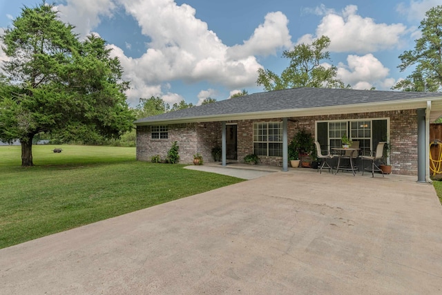 back of house featuring a patio and a lawn