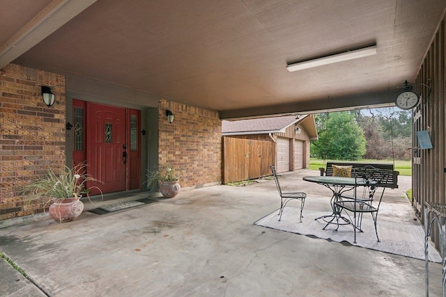 view of patio / terrace featuring an outbuilding and a garage