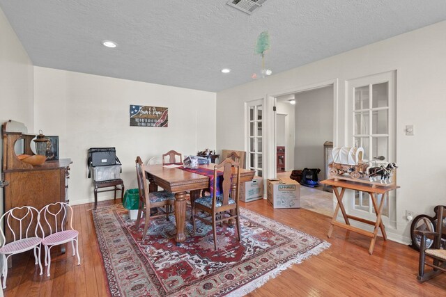 dining area featuring recessed lighting, wood finished floors, and baseboards