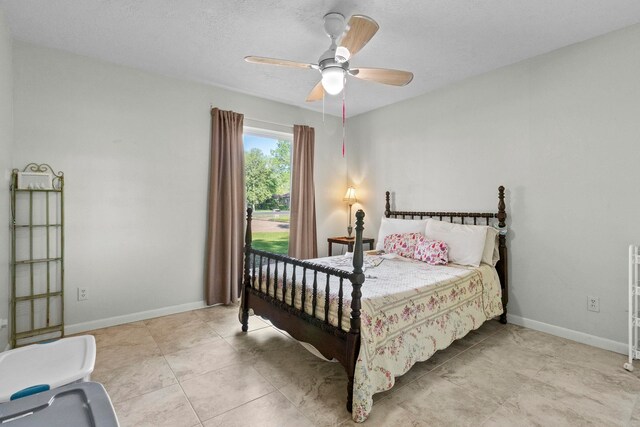bedroom with baseboards and ceiling fan