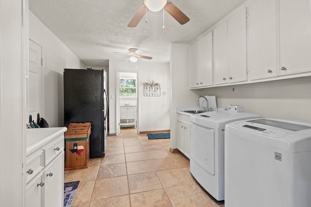 washroom with a ceiling fan, a sink, light tile patterned flooring, washing machine and clothes dryer, and cabinet space