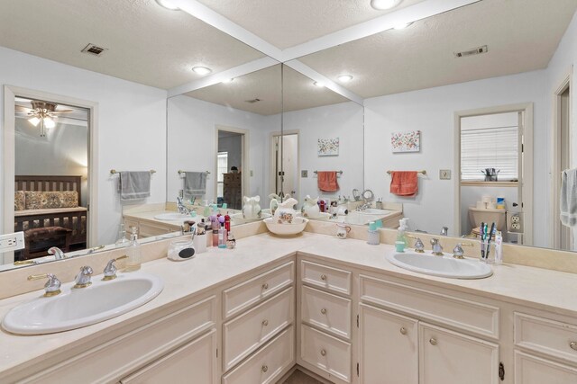 full bathroom with recessed lighting, double vanity, visible vents, and a sink
