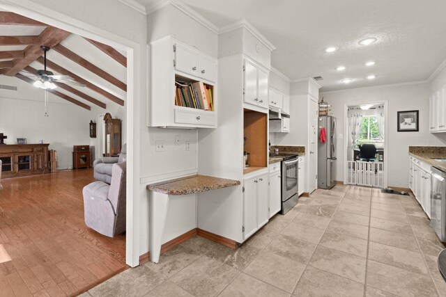 kitchen featuring white cabinets, ornamental molding, a ceiling fan, and stainless steel appliances