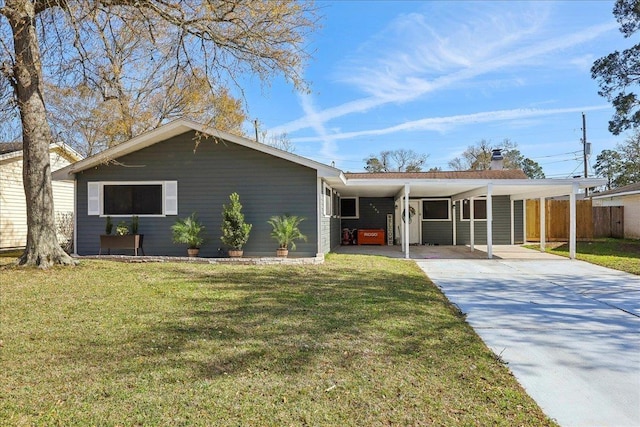 ranch-style home featuring an attached carport, driveway, a front lawn, and fence