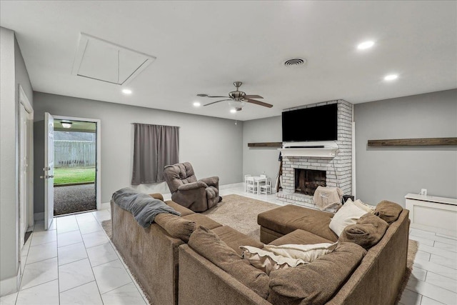 living area with a brick fireplace, recessed lighting, visible vents, and ceiling fan