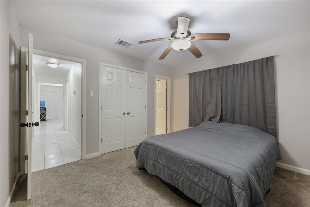 bedroom with a ceiling fan, baseboards, visible vents, a closet, and carpet flooring