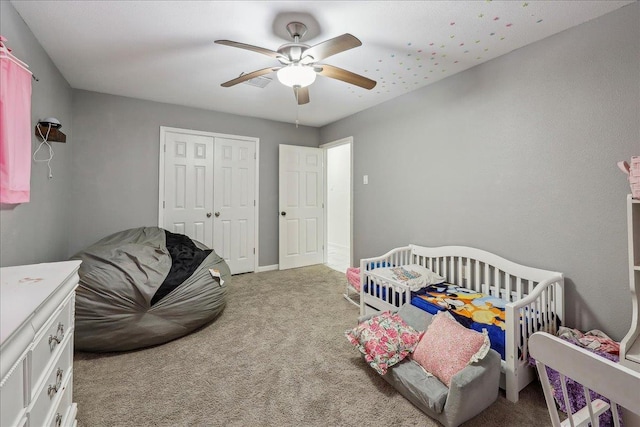 bedroom with a closet, carpet flooring, and ceiling fan