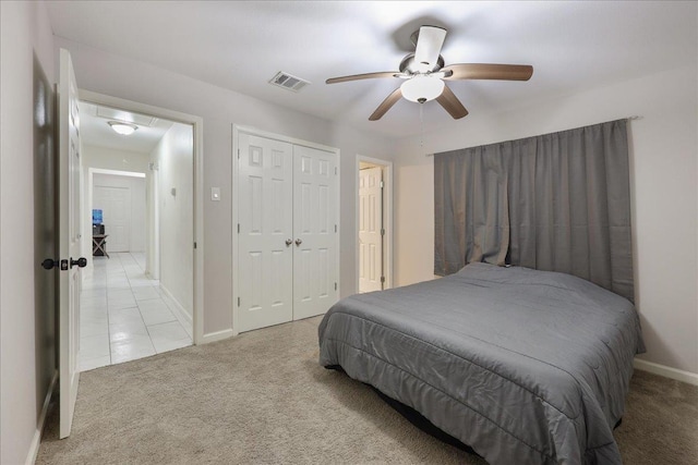 bedroom with visible vents, attic access, carpet floors, a closet, and a ceiling fan