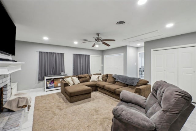 living room with visible vents, a brick fireplace, attic access, recessed lighting, and a ceiling fan