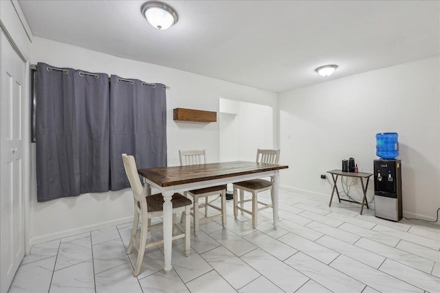 dining room featuring baseboards and marble finish floor