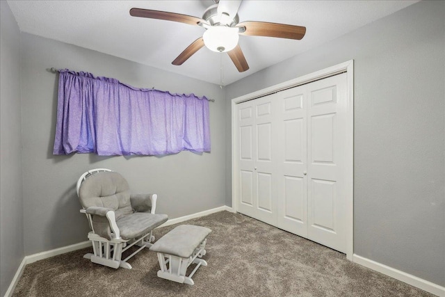 sitting room with baseboards, carpet floors, and ceiling fan