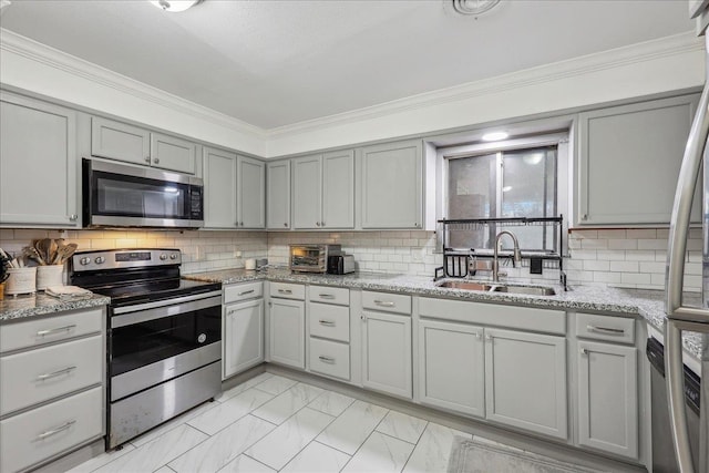 kitchen with a sink, gray cabinetry, stainless steel appliances, marble finish floor, and backsplash