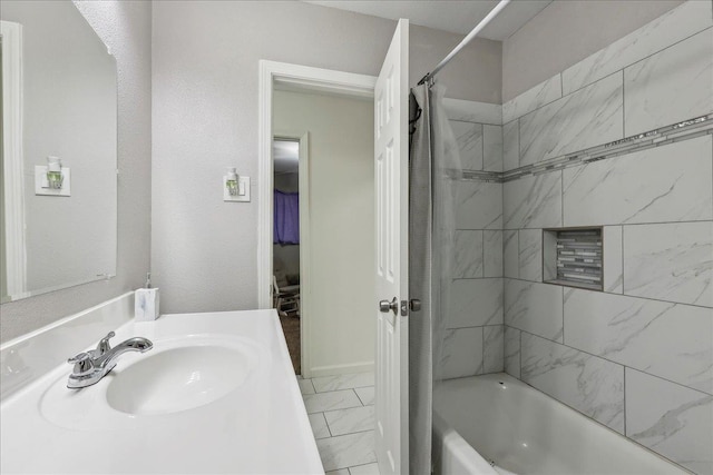 bathroom featuring marble finish floor, vanity, and shower / bathtub combination with curtain