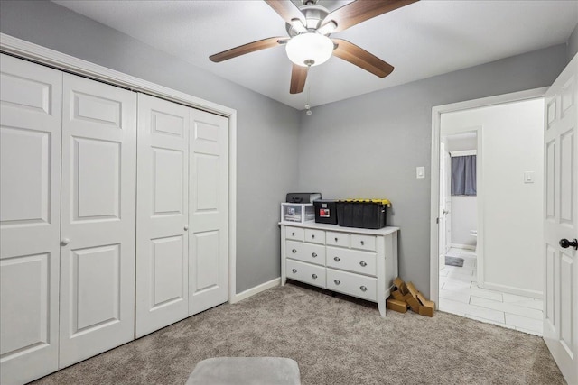 bedroom with a ceiling fan, a closet, carpet floors, and baseboards