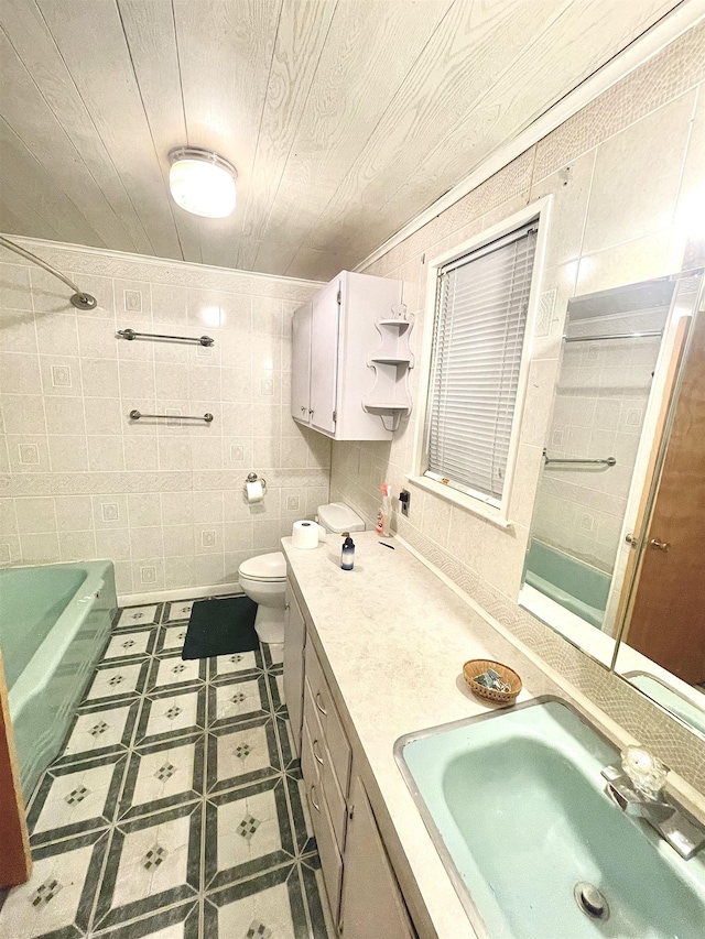 bathroom featuring vanity, a bathing tub, toilet, tile walls, and wood ceiling