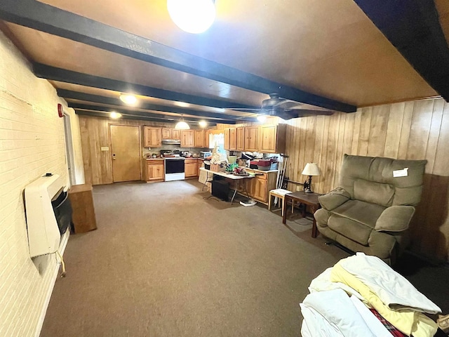 carpeted living room with beamed ceiling and heating unit