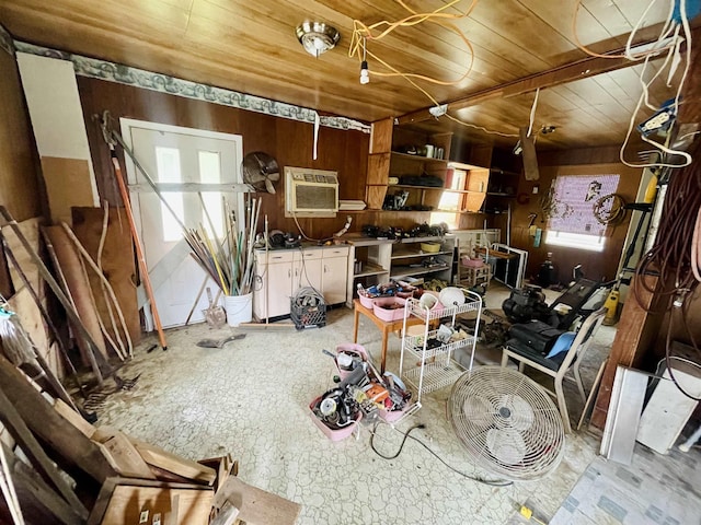 misc room with a wall mounted air conditioner, wooden ceiling, and wood walls