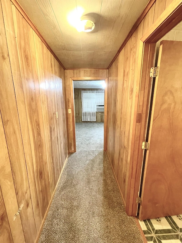 corridor featuring light carpet and wooden walls