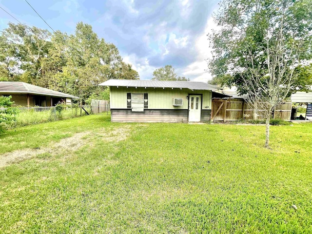 rear view of house with a yard