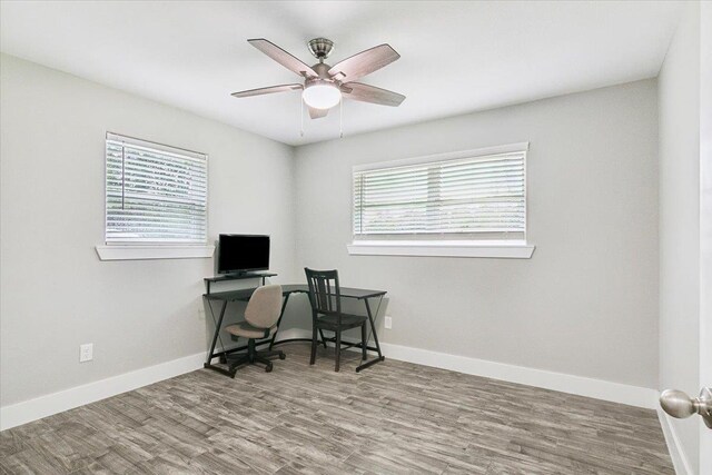 home office with hardwood / wood-style floors, a wealth of natural light, and ceiling fan