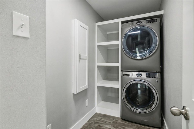 clothes washing area featuring stacked washing maching and dryer