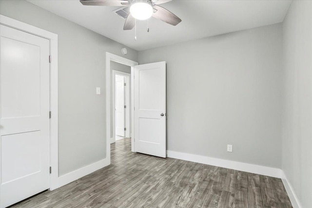 unfurnished bedroom with ceiling fan and light wood-type flooring