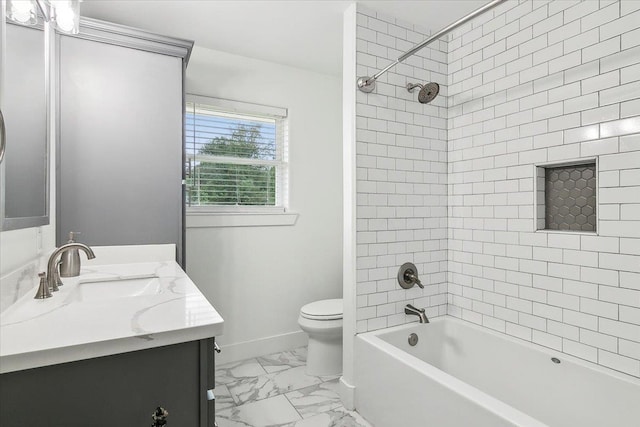 full bathroom featuring vanity, tiled shower / bath combo, and toilet