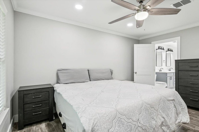 bedroom featuring connected bathroom, ceiling fan, dark hardwood / wood-style flooring, and crown molding