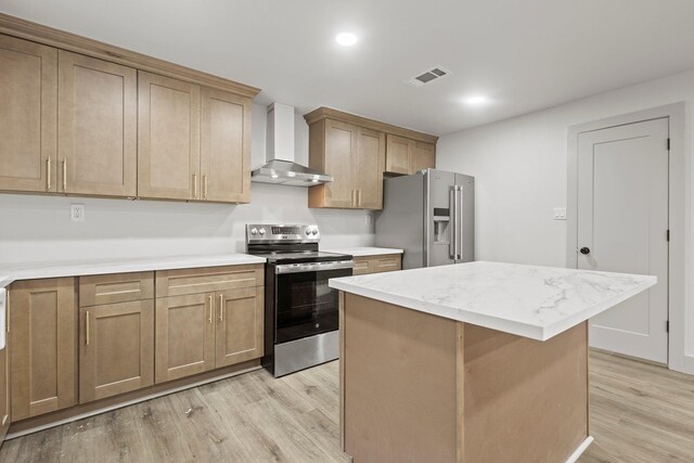 3266 Brent Dr, Orange, TX 77632 - kitchen featuring appliances with stainless steel finishes, wall chimney exhaust hood, light wood finished floors, a kitchen island, and recessed lighting