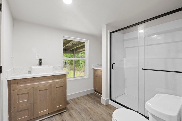 3266 Brent Dr, Orange, TX 77632 - bathroom with vanity, toilet, wood finished floors, a stall shower, and baseboards