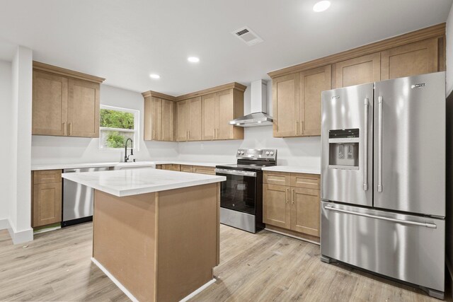 3266 Brent Dr, Orange, TX 77632 - kitchen featuring stainless steel appliances, wall chimney range hood, a sink, light wood finished floors, and recessed lighting