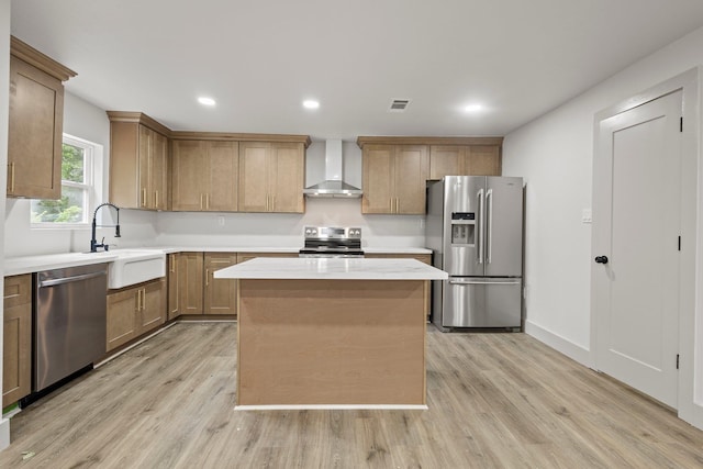 3266 Brent Dr, Orange, TX 77632 - kitchen featuring stainless steel appliances, wall chimney range hood, a sink, light wood-style flooring, and light countertops