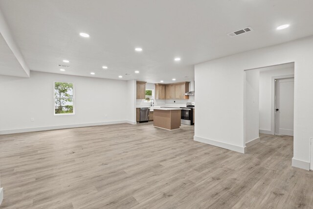 3266 Brent Dr, Orange, TX 77632 - unfurnished living room featuring recessed lighting, light wood-type flooring, baseboards, and a sink